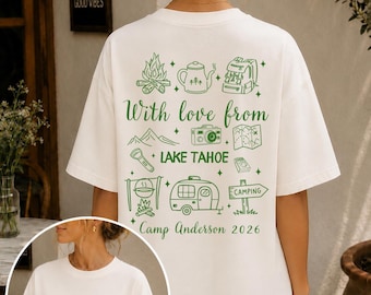 May include: A white t-shirt featuring green camping-themed graphics. The back displays icons of a campfire, kettle, backpack, camera, map, flashlight, trailer, and sign with the text With love from LAKE TAHOE Camp Anderson 2026. The front has a small map icon.