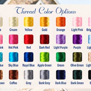 May include: A color chart titled Thread Color Options displaying twenty-eight individual spools of embroidery thread in various shades including white, cream, yellow, gold, orange, pinks, reds, purples, blues, greens, browns, grey, and black.