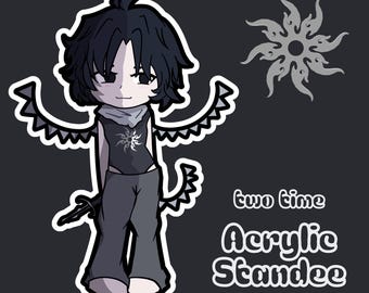 May include: An acrylic standee featuring a chibi-style character with black hair, dark clothing, and wings. The character wears a top with a sun emblem. The text "two time Acrylic Standee" is printed on the right, alongside a sun-shaped icon.