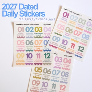 May include: Three sheets of 2027 dated daily stickers featuring twelve numbered months per sheet. Each sticker displays a large number, the month name, and a day of the week above a wavy line. The sheets include monochrome and confetti colorways.