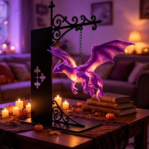 May include: A black metal stand with a decorative scrollwork arm holds a glowing purple dragon figurine suspended by a chain. The dragon features outstretched wings and detailed scales, illuminated from within, creating a vibrant light display.
