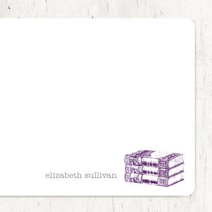 May include: A white card with the text "elizabeth sullivan" printed in black at the bottom. A purple illustration of three stacked books is in the bottom right corner.