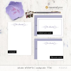 May include: A set of stationery featuring the name "Ellie Hamilton" in a cursive script. The set includes a notepad, folded note cards, and flat note cards. The ink color is wisteria and the envelope color is lilac.