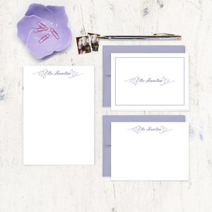 May include: A set of three white stationery cards with a lavender envelope. The cards feature a handwritten script font with the name "Ellie Hamilton" on each card.