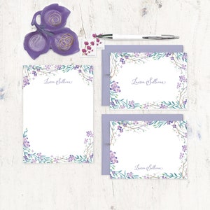 May include: Set of three purple floral stationery cards with a white background and the name "Lauren Sullivan" written in cursive. The cards have a border of purple and green watercolour flowers and leaves.