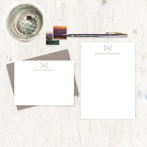 May include: Two white stationery note cards with a gray envelope. The note cards have a simple monogram design with the initials "[h]" and the name "Jennifer Hamilton" printed in gray.
