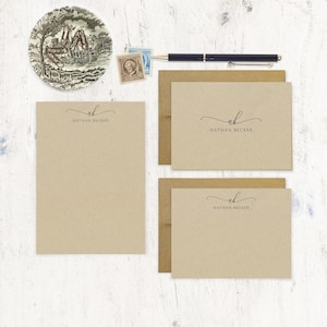 May include: Set of four kraft paper stationery cards with brown envelopes. Each card features a handwritten monogram "NB" with the name "Nathan Becker" printed below.