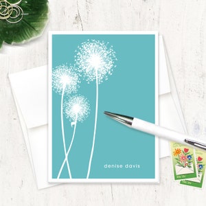 May include: A turquoise blue card with white dandelion silhouettes. The card has the text "denise davis" printed in white at the bottom.