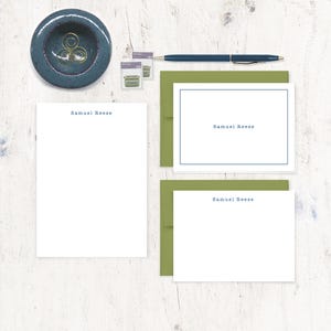May include: A set of personalized stationery featuring the name "Samuel Reese" printed in blue on white paper. The stationery comes with matching envelopes in a green color.