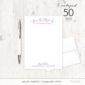 May include: A white notepad with magenta ink. The notepad has a header that says "from the Mom of Ellie & Kayla Nichols". The bottom of the notepad has the name "Avery Nichols", an email address, and a phone number.