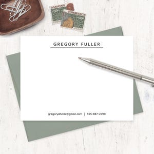 May include: A white stationery card with a black line and the text "GREGORY FULLER" printed in black. The card also includes the text "gregoryafuller@gmail.com | 555-887-2398" printed in black.