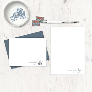 May include: Two blank stationery cards with blue envelopes. The cards have a simple design with the text "Delaney Smith" and the initials "ds" in a cursive font.