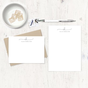 May include: Two white note cards with a brown envelope. The note cards have a simple handwritten monogram "eh" with the name "Ellie Hamilton" printed below.