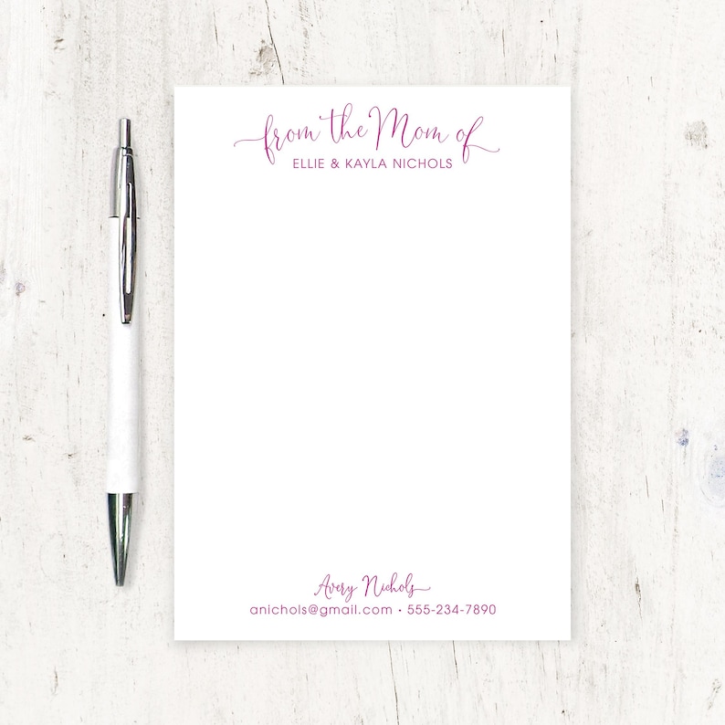 May include: White notepad with pink text that reads "from the Mom of Ellie & Kayla Nichols" at the top and "Avery Nichols anichols@gmail.com 555-234-7890" at the bottom.