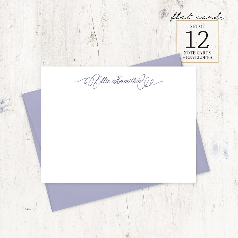 May include: A set of 12 flat note cards with envelopes, featuring a cursive script that reads "Ellie Hamilton". The cards are white and the envelopes are a light purple.