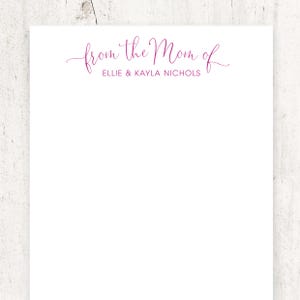 May include: White notepad with the text "from the Mom of Ellie & Kayla Nichols" in pink cursive.
