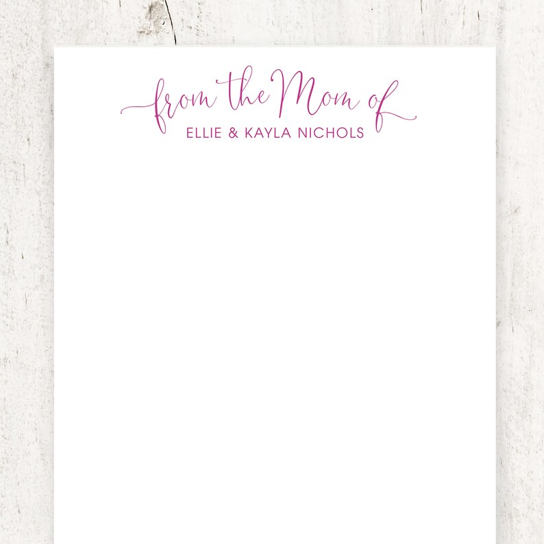 May include: White notepad with the text "from the Mom of Ellie & Kayla Nichols" in pink cursive.
