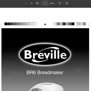 May include: A black and white image of a Breville BR6 Breadmaker. The breadmaker is white with a black digital display and a clear viewing window. The text "Baker's Oven" is printed on the front of the breadmaker.