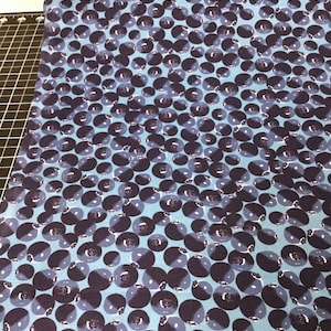 May include: Blue fabric with a repeating pattern of dark blue blueberries on a light blue background.