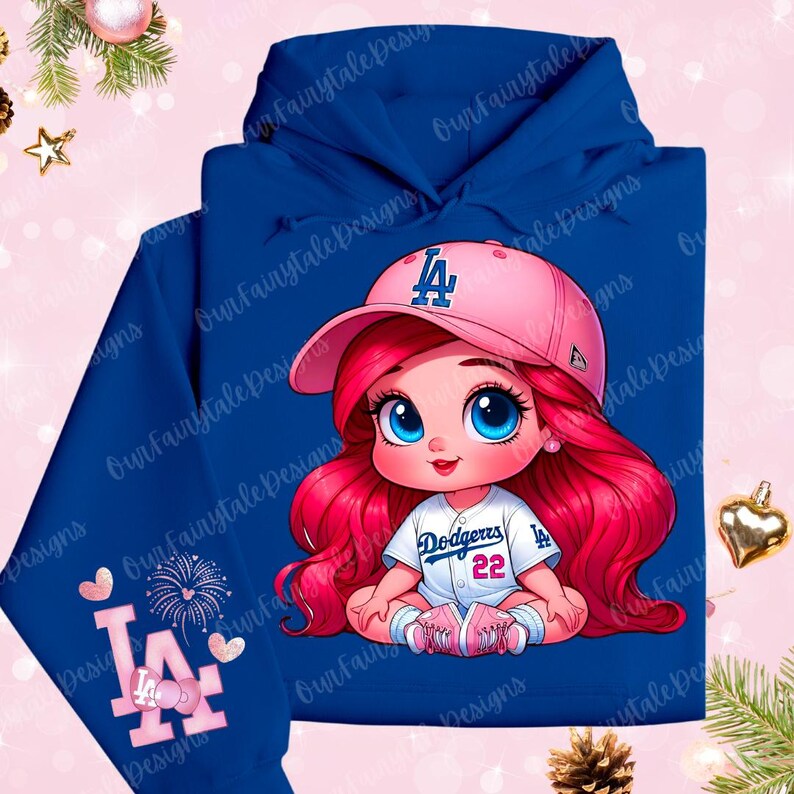 May include: A blue hoodie with a pink and white baseball cap, a pink and white LA logo, and a cartoon girl wearing a Dodgers jersey. The girl has long red hair and blue eyes.