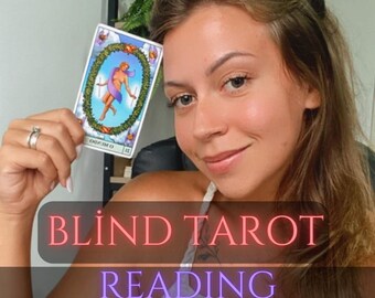 May include: A woman holds up a tarot card with a woman in a purple dress standing on a circle of clouds. The text on the card reads "The World". The text on the image reads "Blind Tarot Reading Same Day".