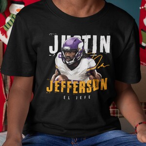 a young man wearing a black shirt with a football player on it