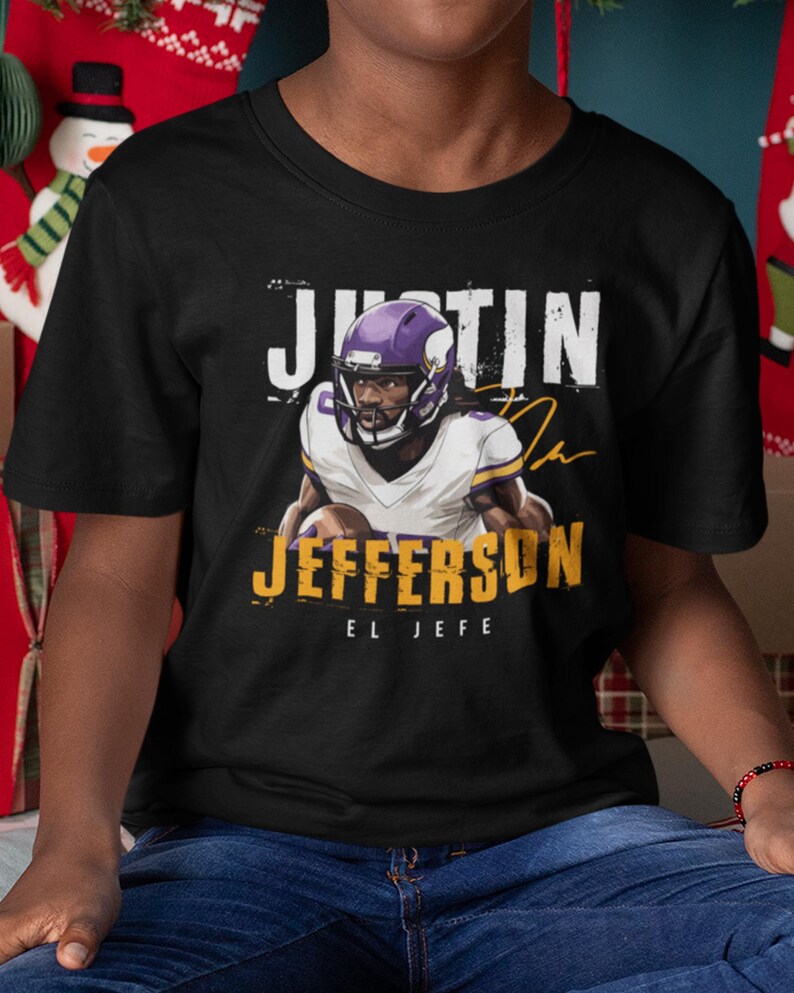 a young man wearing a black shirt with a football player on it