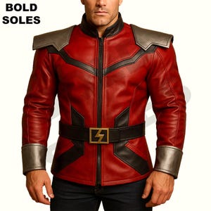 May include: A red leather jacket with black accents and a zipper closure. The jacket has a stand-up collar, long sleeves, and a belt with a gold buckle. The jacket has a bold design with a lightning bolt on the buckle.