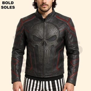 May include: Black leather motorcycle jacket with a red skull design on the front. The jacket has a zipper closure and red accents.