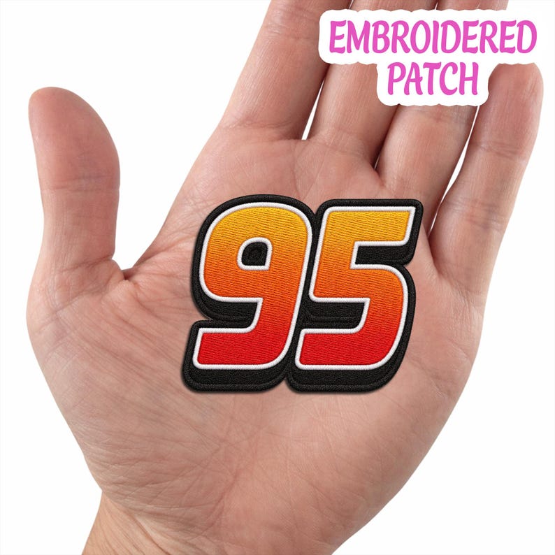 May include: An embroidered patch featuring the number 95 in a gradient of yellow, orange, and red. The digits have a white outline and a thick black border. The text EMBROIDERED PATCH is visible in the upper right corner of the image.