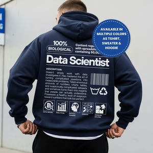 May include: A navy blue hoodie featuring white text on the back that reads 100% BIOLOGICAL Data Scientist, along with a detailed description, a barcode, and five icons labelled Data-Driven, Analytical, Critical-Thinking, Curious, and Problem-Solving.