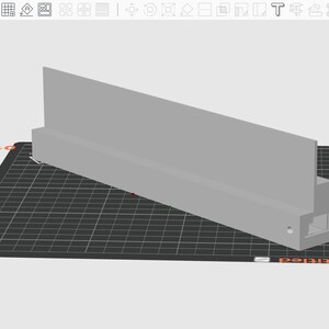 May include: A light gray, rectangular 3D-printed object with a vertical panel and a rectangular base. The object is positioned on a black, grid-patterned surface. The design appears to be a component or part.