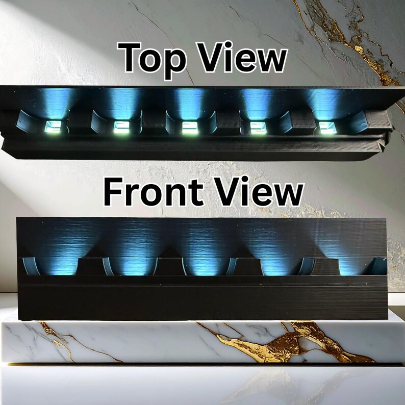 May include: Black rectangular light fixture with six recessed lights emitting blue light. The text "Top View" and "Front View" are visible. The fixture is on a white and gold marble base.