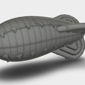 May include: A grey airship model with a rounded body and vertical fins. The airship has a detailed design with visible panel lines and a rear stabilizer. The image is a 3D render, showcasing the airship against a plain background.