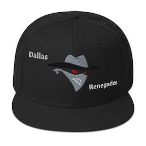 May include: Black baseball cap with a flat brim. The cap features the text "Dallas" and "Renegades" in white, along with an embroidered graphic of a masked figure with red eyes.