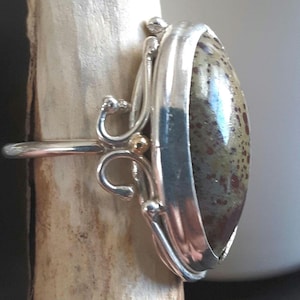 speckled green gem set in sterling silver with 14kt gold accent balls