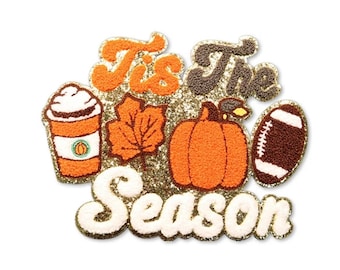 May include: A glittery patch with the text "Tis The Season" and autumn-themed images. The images include a coffee cup, a leaf, a pumpkin, and a football. The text and images are in shades of orange, brown, and white.
