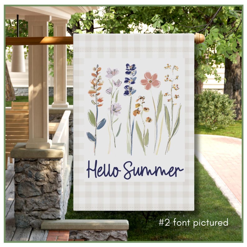 Garden flag, featuring a soft watercolor illustration of delicate wildflowers in shades of lavender, peach, and blue. Set against a classic light beige gingham border, the elegant navy script reads "Hello Summer," creating a warm invitation for guests. This durable, double-sided flag is perfect for spring and summer decor, adding a touch of cottagecore aesthetic to your flower beds or walkway.