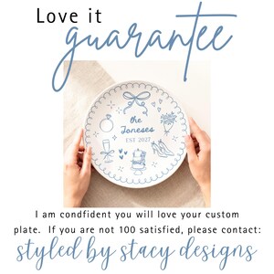 May include: A round white ceramic plate featuring blue line art illustrations of a bow, a diamond ring, a bouquet, a champagne flute, a wedding cake, and high heels. The text reads "the Joneses" and "EST 2027" in the center of the plate.