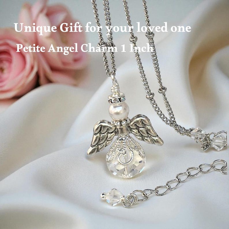 May include: A silver-toned angel charm necklace with a clear crystal body, pearl head, and detailed wings. The charm is 1 inch in size and hangs from a delicate chain. The text reads "Unique Gift for your loved one Petite Angel Charm 1 Inch".