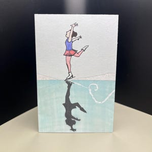Cartes Pour Les Fêtes La réflexion du patineur sur glace