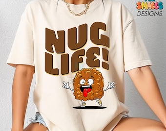 May include: A white t-shirt with the text "NUG LIFE!" in brown letters. A cartoon chicken nugget with a smiling face and tongue sticking out is below the text.
