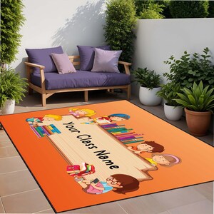 May include: Orange rug with a wooden sign that says "Your Class Name". The sign is surrounded by cartoon children holding books.