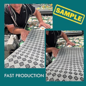 May include: A person operating a machine to cut fabric. The fabric has a black and white checkered pattern with white dots. The text "FAST PRODUCTION" is visible at the bottom of the image. The word "SAMPLE" is stamped in yellow on a red rectangle in the upper right corner of the image.