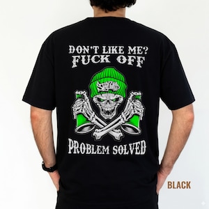May include: Black t-shirt with a graphic design featuring a skull wearing a green beanie and holding green spray paint cans. The text "DON'T LIKE ME? FUCK OFF" and "PROBLEM SOLVED" are printed above and below the skull.