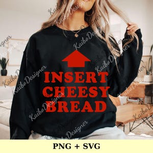 May include: Black sweatshirt with the text "INSERT CHEESY BREAD" in red, with a red arrow pointing upwards. The sweatshirt is a casual style, suitable for everyday wear. The design is a fun, food-themed graphic.