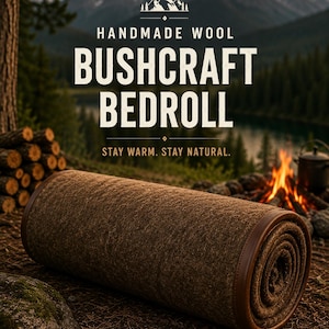 May include: A brown, rolled wool bedroll featuring a smooth leather-like trim along the edges. The text on the image reads: HANDMADE WOOL BUSHCRAFT BEDROLL. STAY WARM. STAY NATURAL. The bedroll is positioned horizontally on a dark, textured ground.