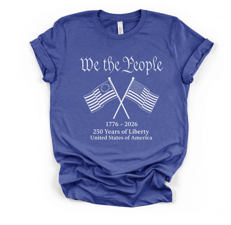 May include: Blue t-shirt with the text "We the People" in white script above crossed American flags. Below the flags is the text "1776-2026 250 Years of Liberty United States of America."