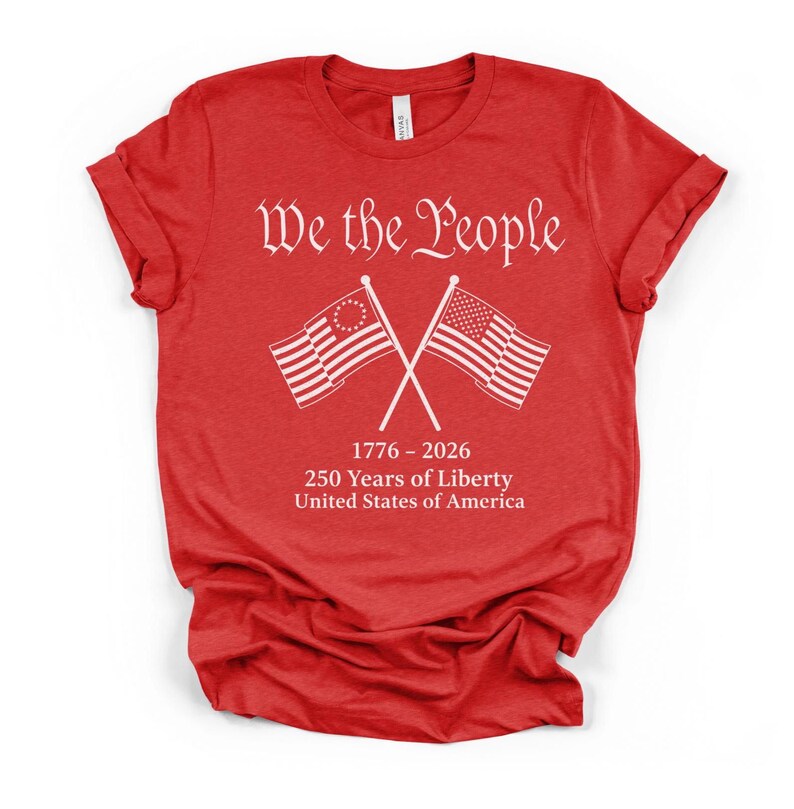 May include: A red t-shirt with white text and graphics. The text reads "We the People" above crossed American flags. Below the flags is "1776 - 2026 250 Years of Liberty United States of America."