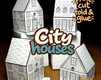 Puede incluir: Cuatro casas de papel con diseños de líneas en blanco y negro que muestran ventanas, puertas y tejas. El texto "print cut fold & glue", "City houses" y "Timeless paper Project" está superpuesto sobre la imagen de las casas.